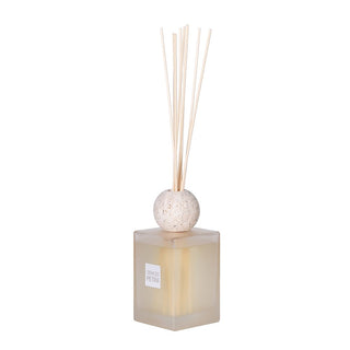 Sleek SENCES Petra scent diffuser with frosted glass bottle, travertine lid, and reed sticks – stylish home fragrance decor
