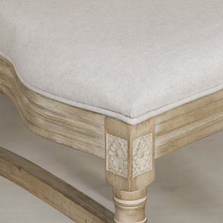 Close-up of the Salcombe chair's padded natural linen seat and cane back