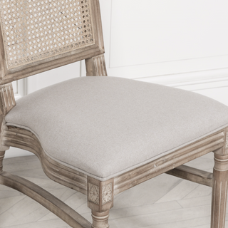 Close-up of the Salcombe chair's hand-woven rattan cane back in a limewashed frame