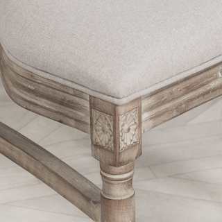 Detail of the Salcombe chair's carved floret corner and fluted limewashed leg