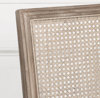 Close-up of the Salcombe chair's hand-woven rattan cane back in a limewashed frame