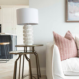 Modern Samsara Table Lamp styled on glass side table next to sofa in living room