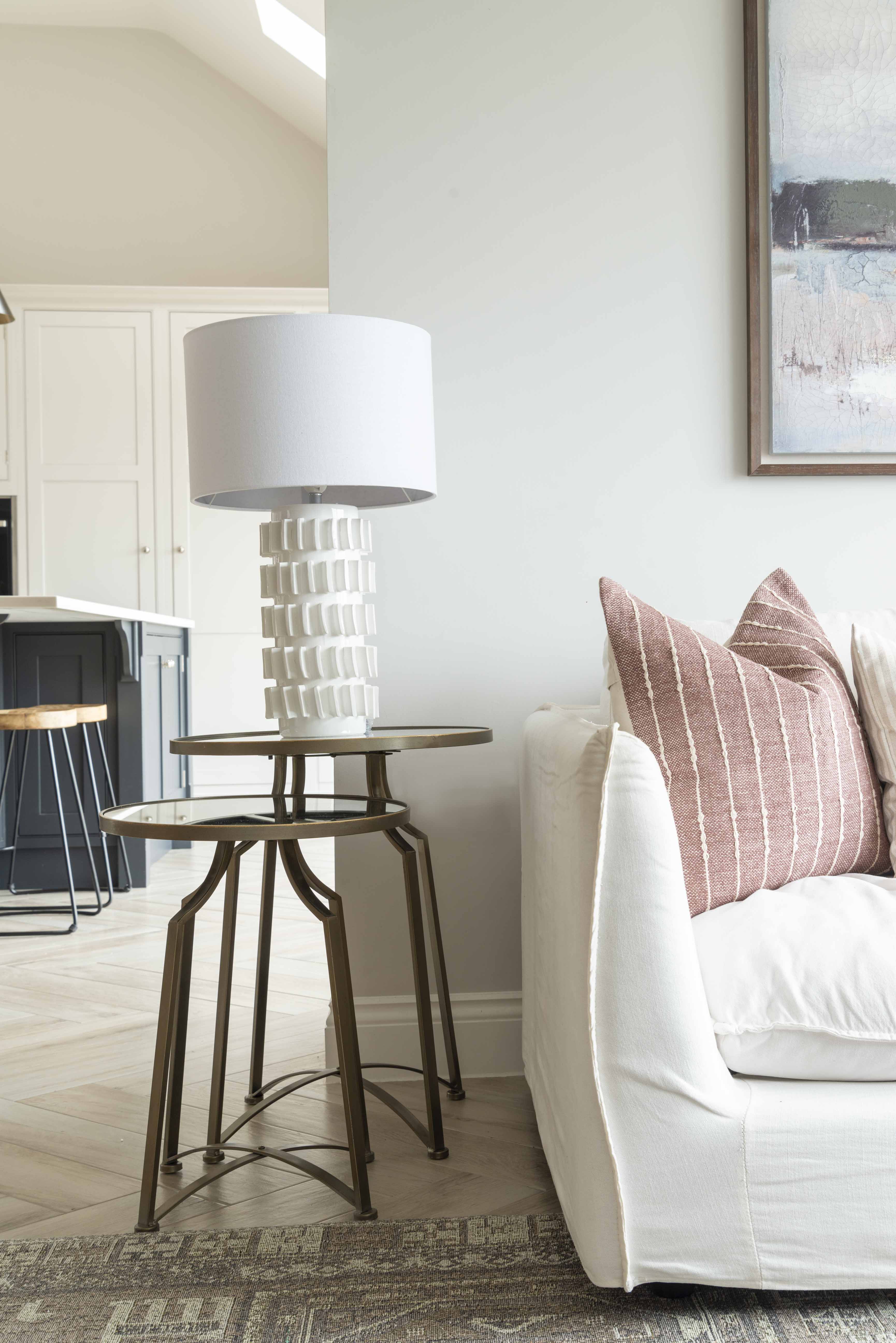 Modern Samsara Table Lamp styled on glass side table next to sofa in living room