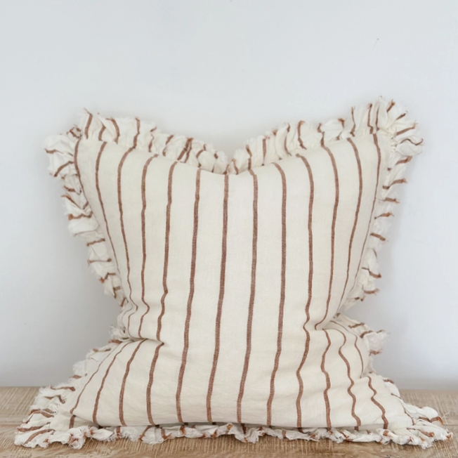 A beautiful linen cushion in cream with brown stripe running through and ruffled edges