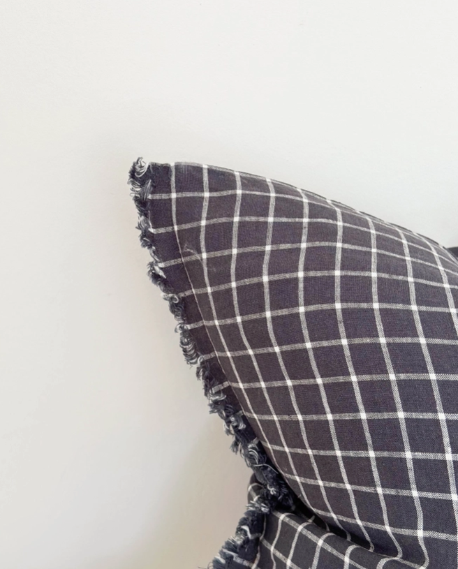 Navy Check Cushion, complete with a feather inner and adorned with a frayed edge and zip closure