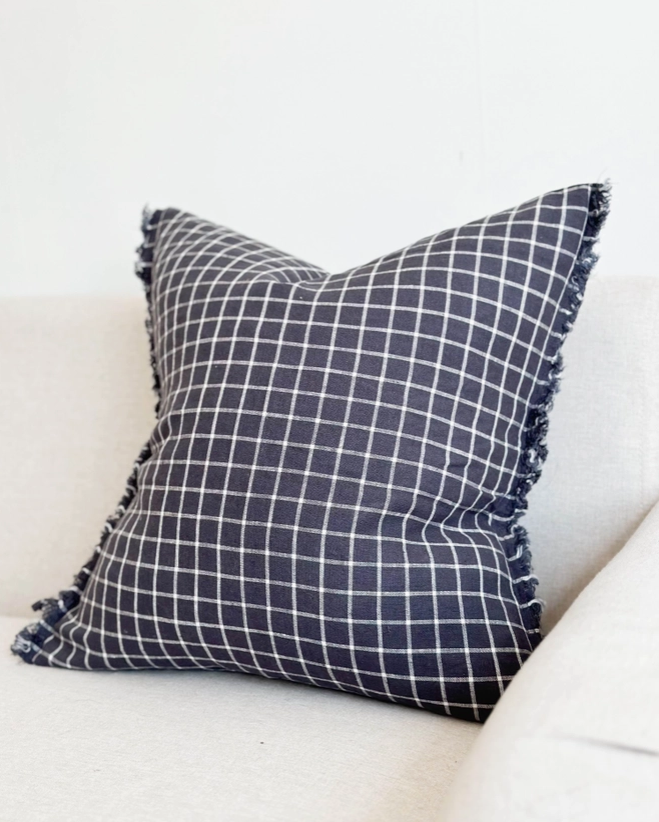 Navy Check Cushion, complete with a feather inner and adorned with a frayed edge and zip closure