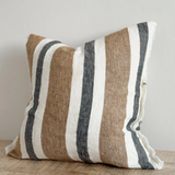 Navy and brown striped cushion cover with linen look fabric displayed on a wooden surface