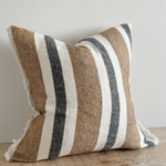 Navy and brown striped cushion cover with linen look fabric displayed on a wooden surface