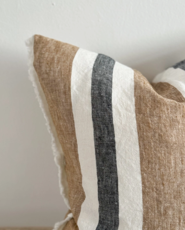 A stunning striped cushion in Navy, brown and Off white with a fringed edge detail.