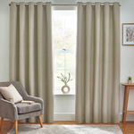 Beige curtains with grommets in a living room setting with a chair and small table.