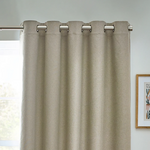 Beige curtain with metallic rings on a gray wall background