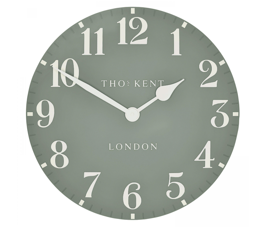 Round wall clock with white numbers and hands on a light gray background, featuring the brand 'Tho: Kent'.