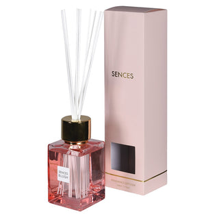 Sences Blush 500ml reed diffuser in blush-pink glass bottle with polished gold cap and white reeds, alongside branded pink gift box