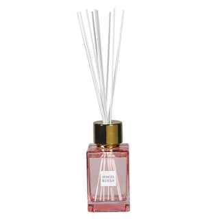 Sences Blush square-cut blush-pink glass diffuser bottle with gold cap, tall white reeds and Sences Blush label