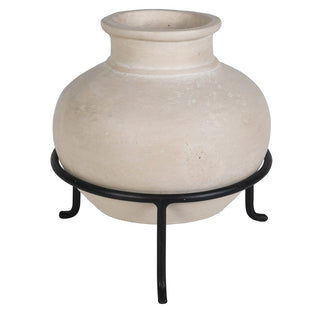 A round, textured beige ceramic pot with a flared rim, displayed on a black metal stand against a plain white background.