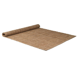 Sofia handwoven jute rug in natural unbleached tone with dense flat-weave construction, partially rolled, 160 by 230cm