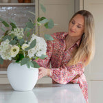 A gorgeous bouquet of white Ranunculus, white Hydrangea, white Meadow Spray and a foliage base of Silver Dollar Eucalyptus&nbsp;