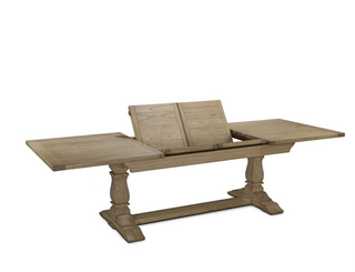 Stourton dining table mid-extension, showing the two internal butterfly leaves folding up from inside the table