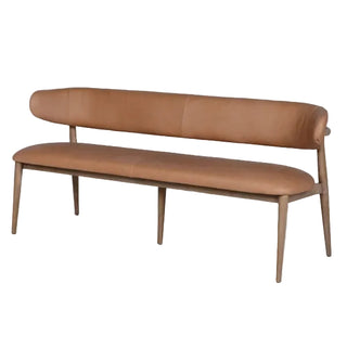 A mid-century modern bench with a curved tan leather seat and backrest, supported by a light wood frame with tapered legs.