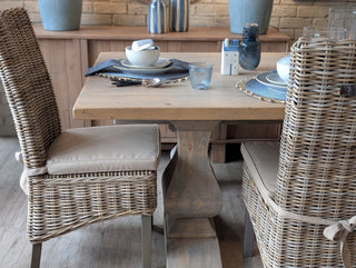 Dining table set with chairs in a rustic interior setting