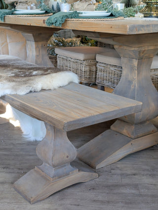 Wooden dining table with benches in a rustic setting
