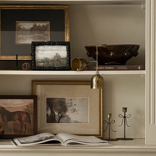 Faux cedar garland draped across a built in bookcase and trailing down one side