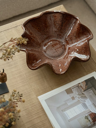 Terra brown ruffled ceramic dish with a glossy speckled glaze, seen from above