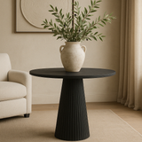 The Salisbury Ribbed Occasional Table in blackened oak, oak veneer, and MDF features a beautifully ribbed base for a touch of sophistication and elegance.
