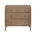 Natural wood 3-drawer dresser with rattan top, brass ring handles, and a warm Mindi veneer finish – ideal for boho or coastal bedrooms.