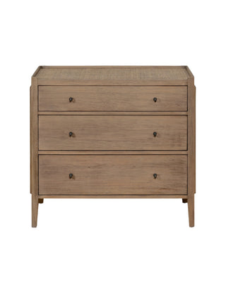 Natural wood 3-drawer dresser with rattan top, brass ring handles, and a warm Mindi veneer finish – ideal for boho or coastal bedrooms.