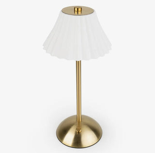 Table lamp with white shade and gold base on a white background