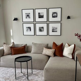 Hampnett velvet cuffed rectangle cushion in carnelian in a living room setting