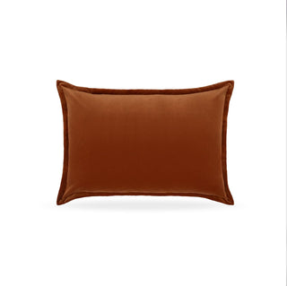 Hampnett velvet cuffed rectangle cushion in carnelian orange-brown on a sofa