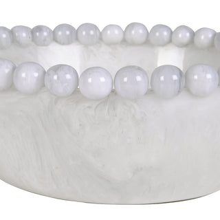 A close-up of a white marble bowl with a beaded rim, showing polished round white beads set around the edge against a white background.