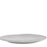 White ceramic plate with decorative edge on a white background