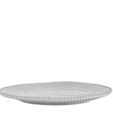 White ceramic plate with decorative edge on a white background