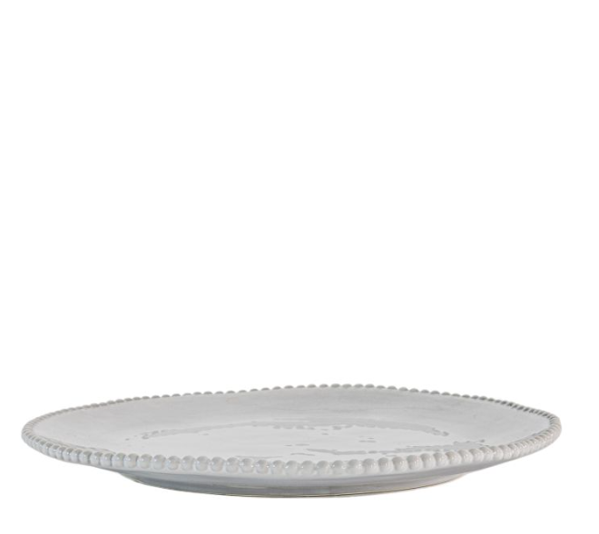 White ceramic plate with decorative edge on a white background