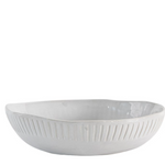 White ceramic bowl with textured design on a white background