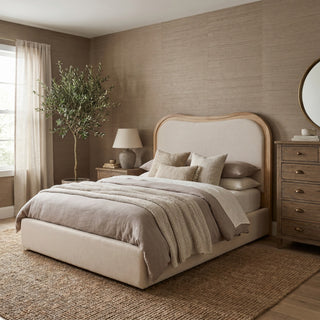 Wycombe curved upholstered bed with arched oak frame and natural linen headboard in a neutral bedroom