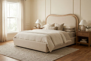 Wycombe curved upholstered bed with arched oak frame and natural linen headboard in a neutral bedroom