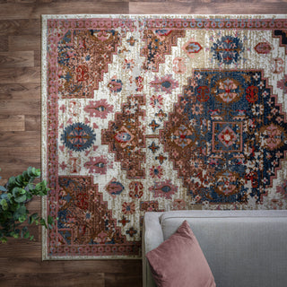 Zola Aras traditional rug in terracotta and blue styled in a living room