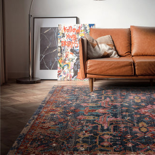 Zola Evin traditional rug in turquoise and pink styled in a living room