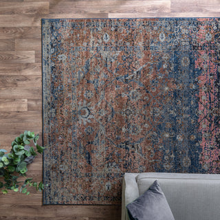 Zola Fasa traditional rug in terracotta and pink styled in a living room