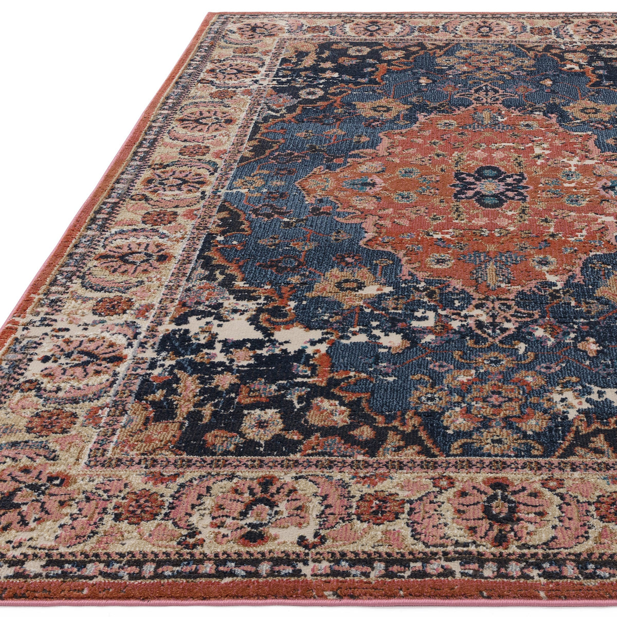Close-up of the Zola Heris rug pattern in blue and rust