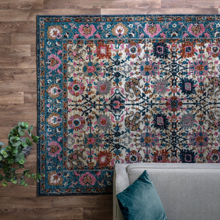 Zola Sarab traditional rug in turquoise and pink styled in a living room