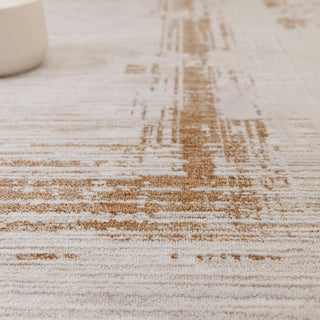 Close-up of the Anders bordered rug in ivory and golden brown showing the space-dyed pile
