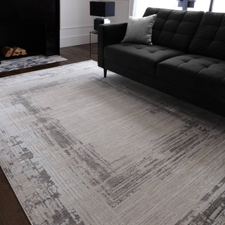 Anders bordered rug in ivory and ash grey styled in a living room