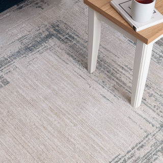 Close-up of the Anders bordered rug in ivory and powder blue showing the space-dyed pile