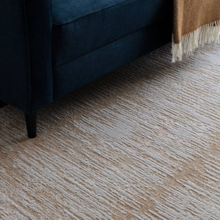 Close-up of the Anders brushstroke rug in soft cream and taupe showing the space-dyed pile
