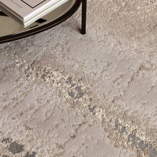 Close-up of the Aurora metallic rug in cliff showing its high shine abstract pattern